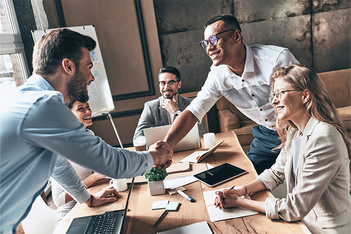 A group of team members inside a conference room working