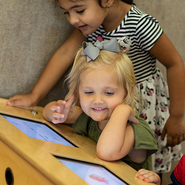 Kids working on iPads at a table