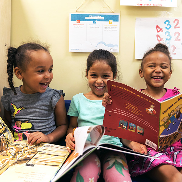 Girls reading and laughing