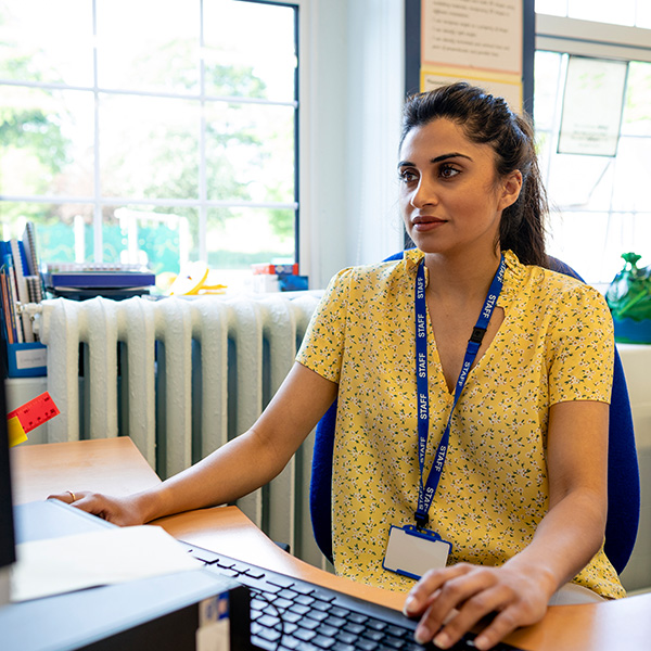 School Director at her desk working on computer