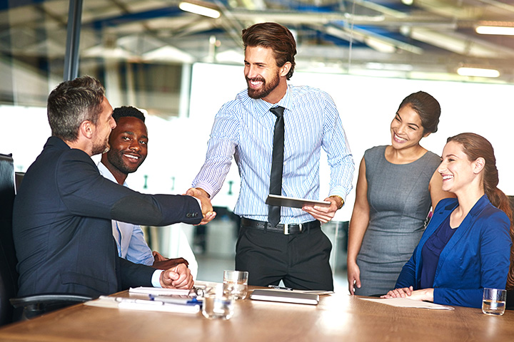 Five coworkers inside a conference room