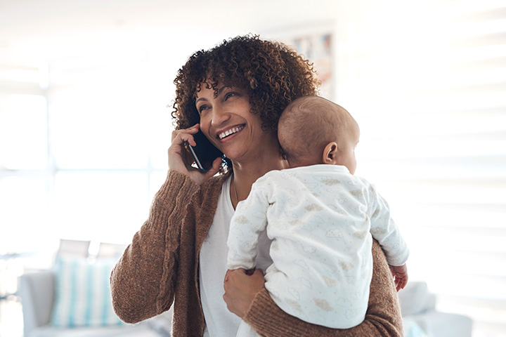 Mom talking on the phone holding her baby