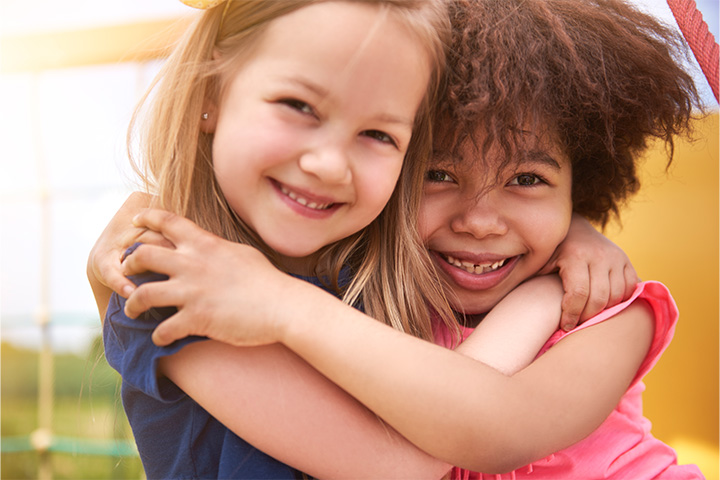 Two girls hugging and smiling